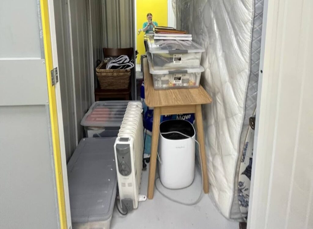 Interior of a student storage unit in Wellington filled with various items such as boxes, mattress, and furniture, showing space utilisation.