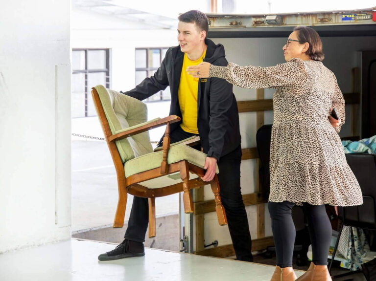 People loading furniture into a self storage facility.