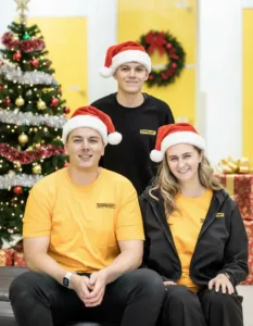 storestuff-team-christmas-2025-tom-peter-staff-santa-hats-petone-wellington-storage